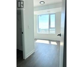 A hallway with a sliding glass door leading to a balcony.