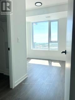 A hallway with a sliding glass door leading to a balcony.