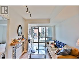 A living room with a couch, a coffee table, and a fireplace.