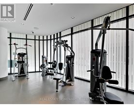 A gym with a variety of equipment including a treadmill, a stationary bike, and a rowing machine.