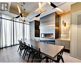 A modern dining room with a long table and chairs.