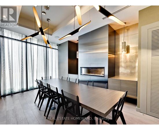 A modern dining room with a long table and chairs.