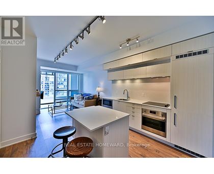 A modern kitchen with white cabinets and a large island.