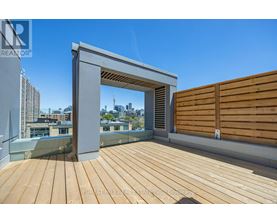 A wooden deck with a white overhang and a wooden fence.