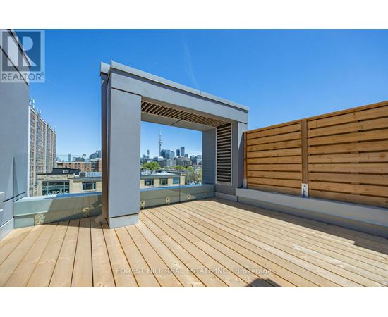 A wooden deck with a white overhang and a wooden fence.