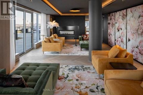 A living room with a green sofa and a fireplace.