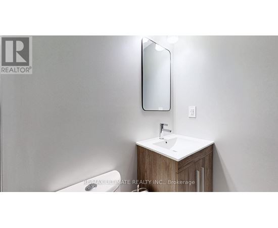 A bathroom with a sink, mirror, and toilet.