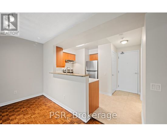 A kitchen area with a counter and cabinets is visible.