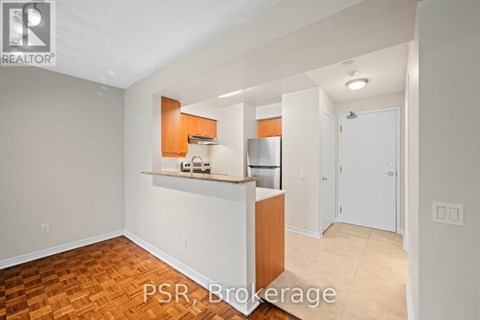 A kitchen area with a counter and cabinets is visible.