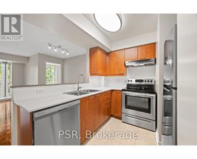 A kitchen with wooden cabinets and stainless steel appliances.