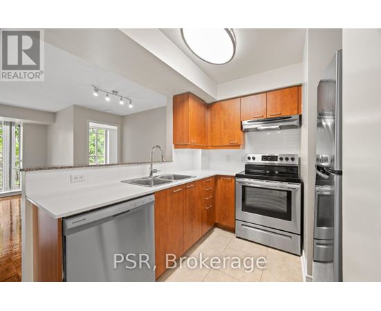 A kitchen with wooden cabinets and stainless steel appliances.