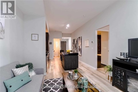 A living room with a grey couch and a black cabinet.