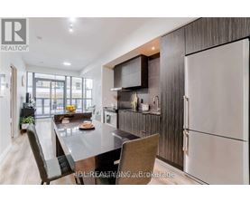 A modern kitchen with a dining table and chairs.