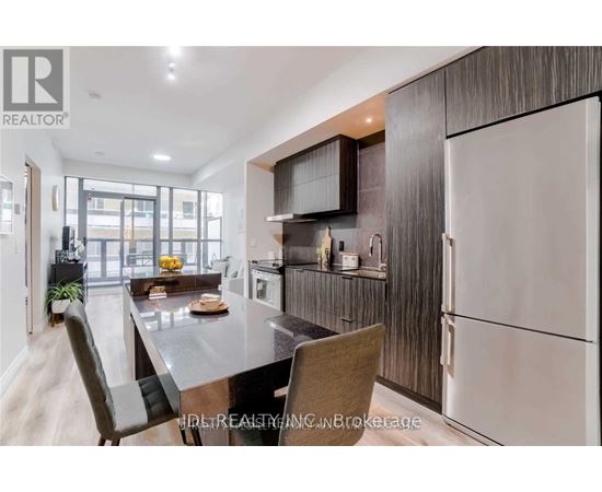 A modern kitchen with a dining table and chairs.