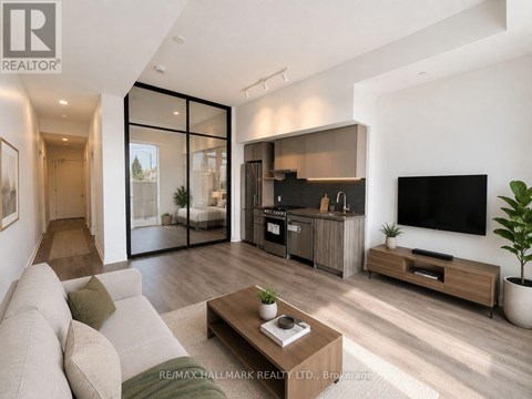 A modern living room with a large couch and a flat screen TV.