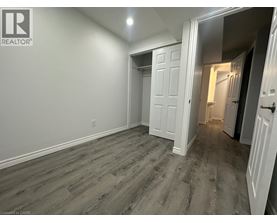 A room with a wooden floor and white walls.