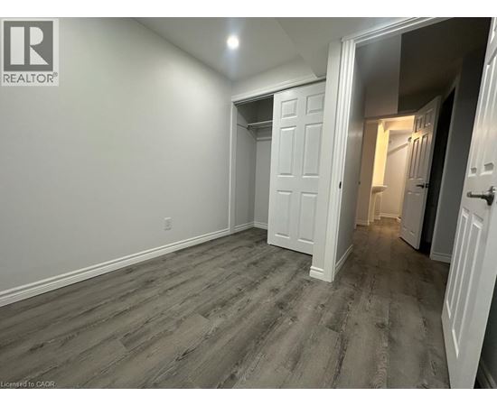 A room with a wooden floor and white walls.