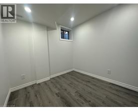 A room with wooden flooring and white walls.