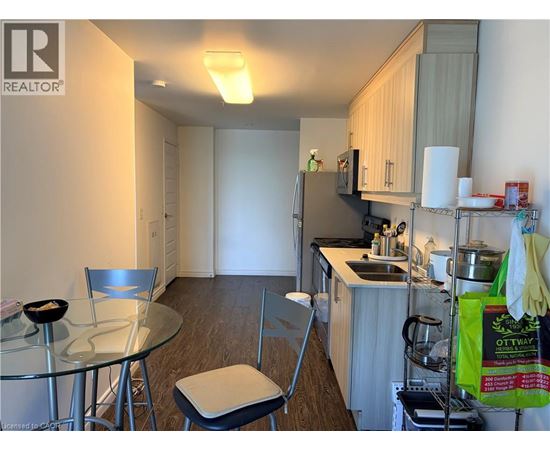 A kitchen with a table and chairs.