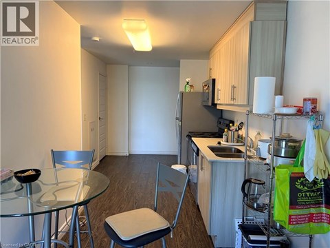 A kitchen with a table and chairs.
