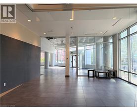A large, empty room with a REALTOR® logo on the wall.