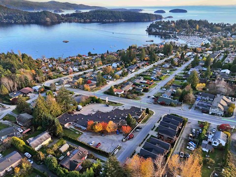 A small town with a lake in the background.