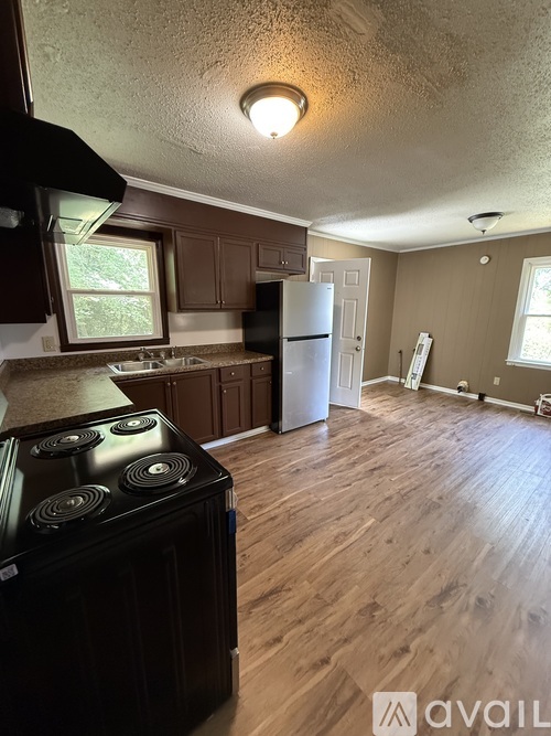 A kitchen with a black stove top oven.