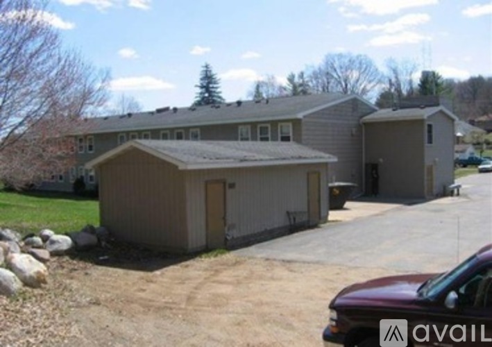 A house with a brown roof and a garage is available for rent.
