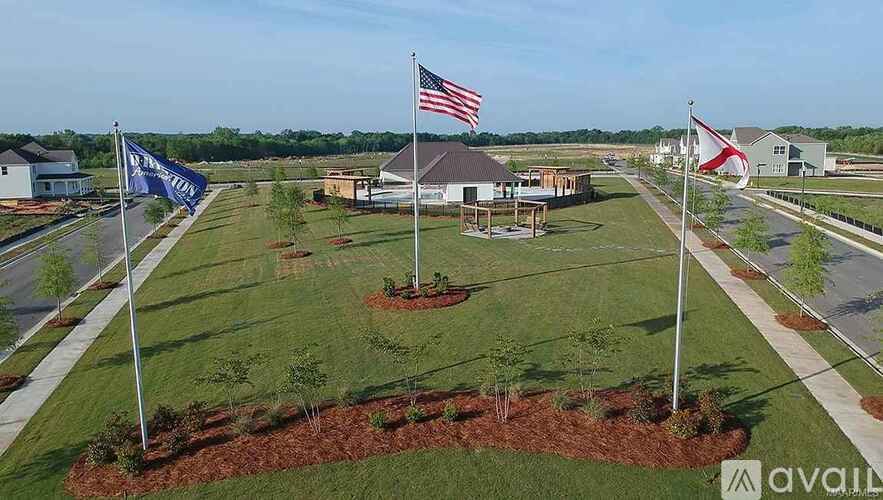 A flag is flying in front of a building with a flagpole.