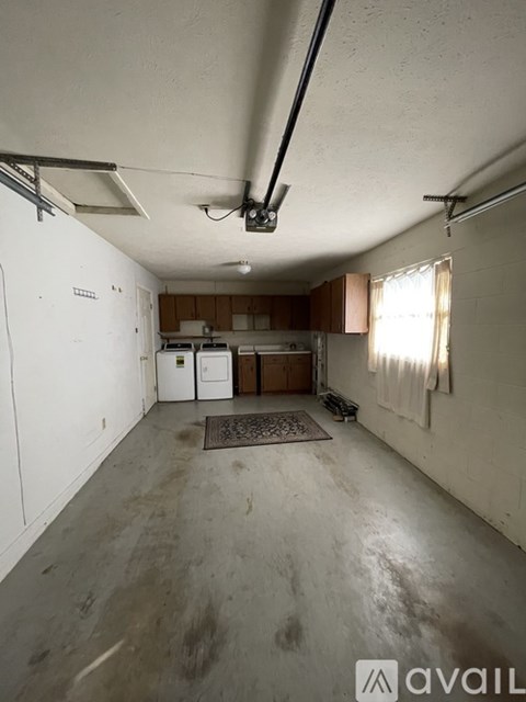 A spacious garage with a concrete floor and white walls.
