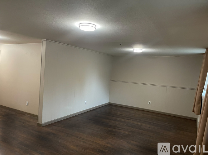 A room with wooden floors and white walls.