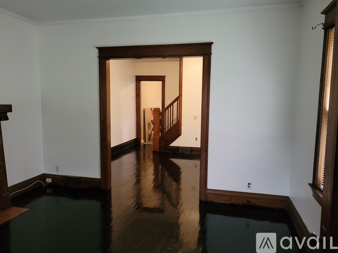 A room with a wooden staircase and a glass floor.