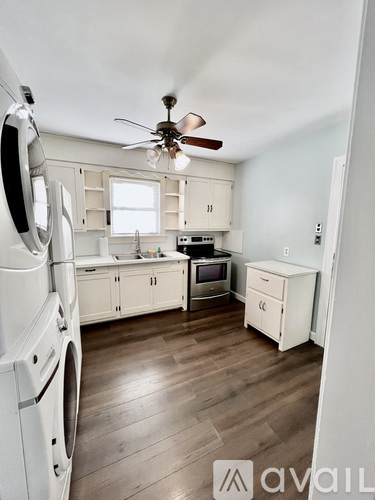 A small, clean, and well-organized laundry room with a washer and dryer.
