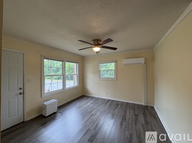 A room with a ceiling fan and a window.