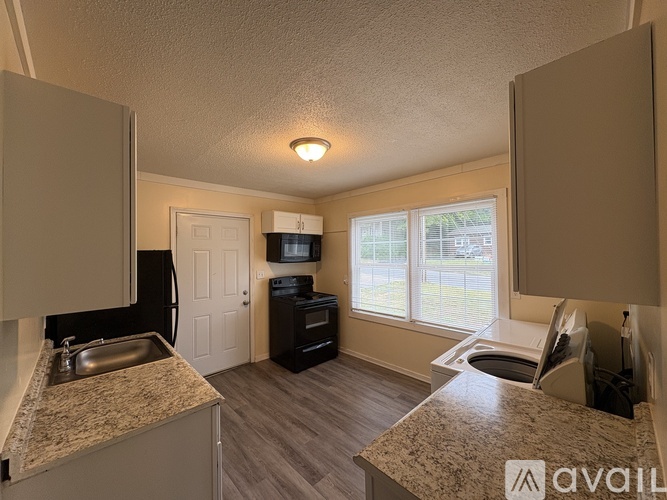 A kitchen with granite countertops and a sink.