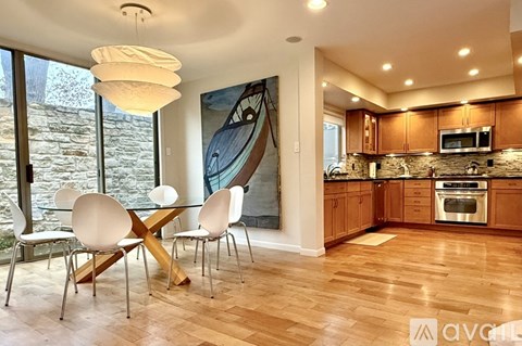 A modern kitchen with a dining table and chairs.