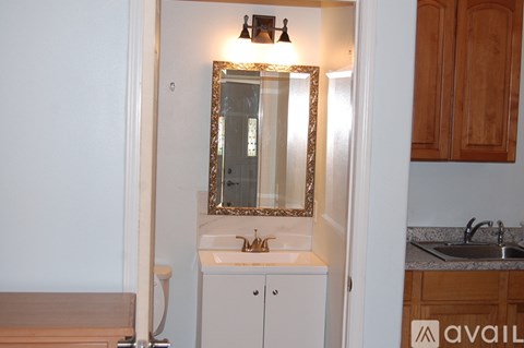 A bathroom with a sink and mirror.
