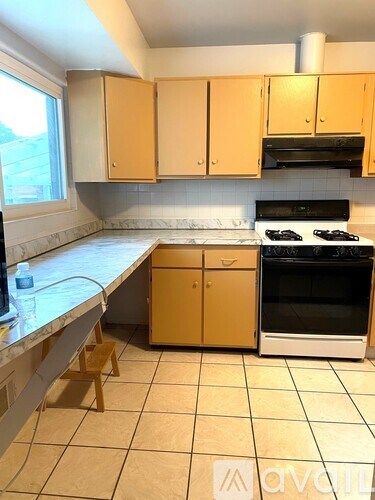 A kitchen with a stove top oven and a dishwasher.