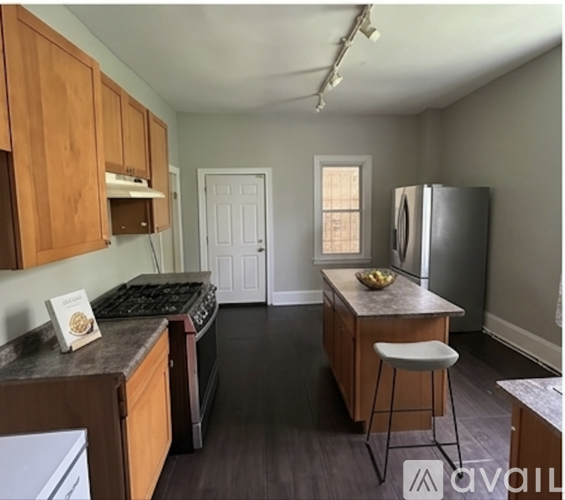 A kitchen with wooden cabinets and a black stove top oven.