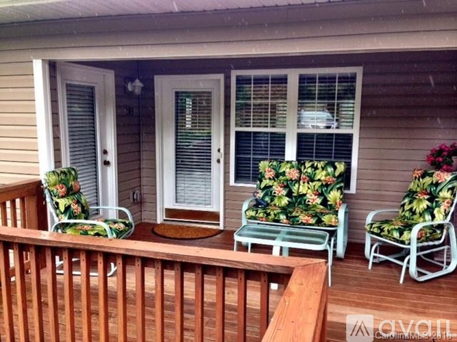 A wooden deck with a table and chairs.