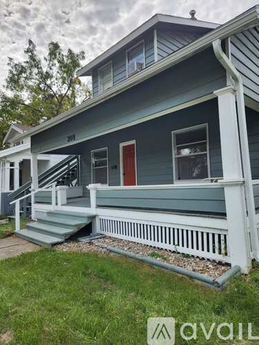 A house with a red door and a white porch.