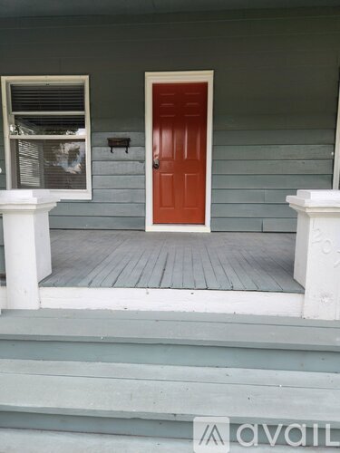 A red door is on the front of a house.