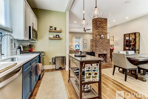 A kitchen with a blue cabinet and a brick chimney.