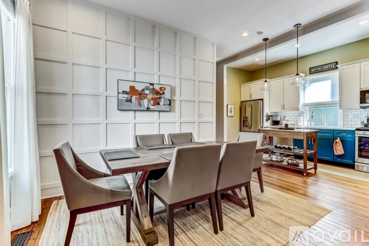A modern dining room with a table set for four.