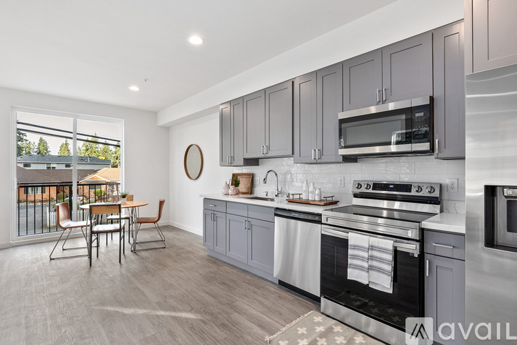 A modern kitchen with a dining table and chairs.
