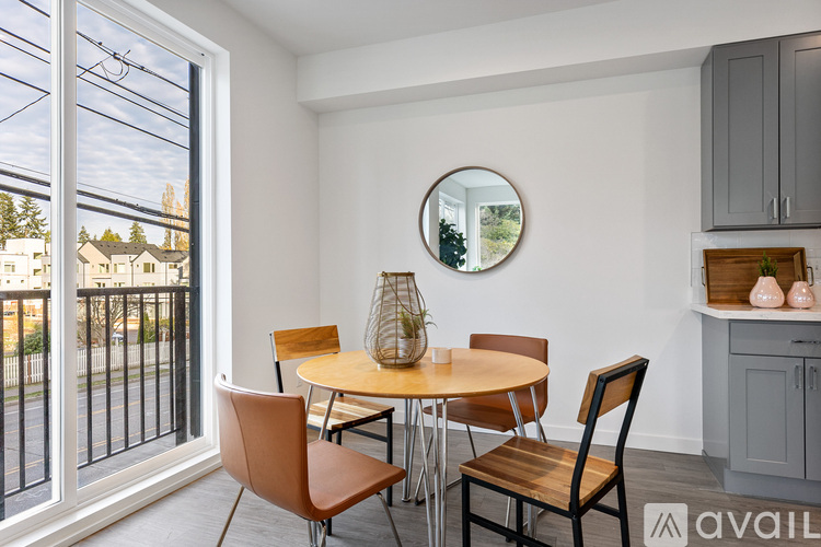 A dining room with a table and chairs.