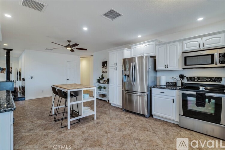 A kitchen with white cabinets and stainless steel appliances.
