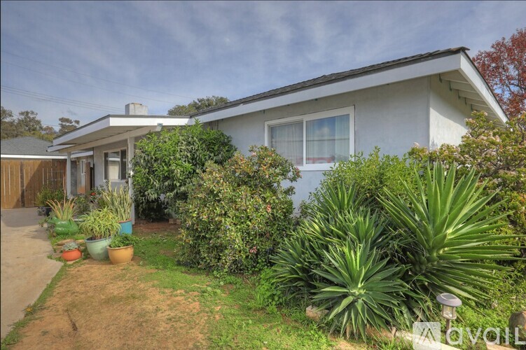 A house with a garden in front of it is for sale.