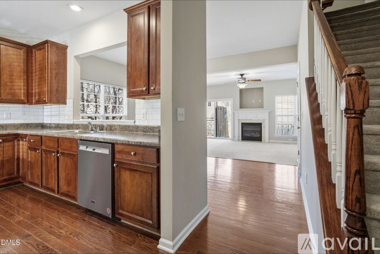 A kitchen with wooden cabinets and a stainless steel dishwasher.