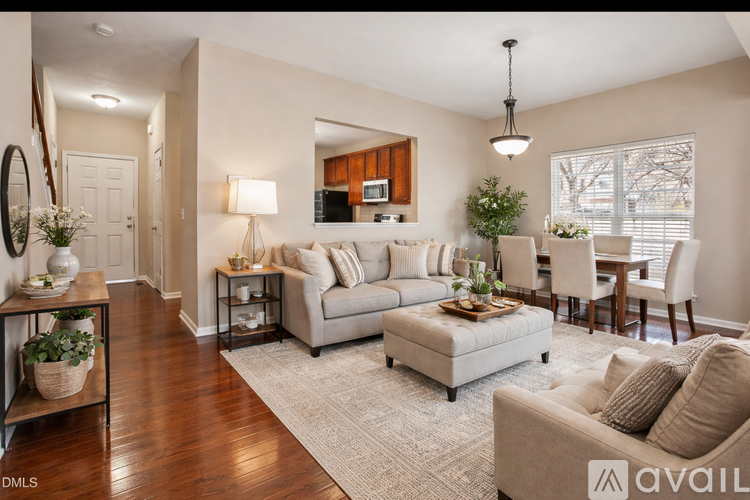 A well-lit living room with a grey sofa and a wooden coffee table.